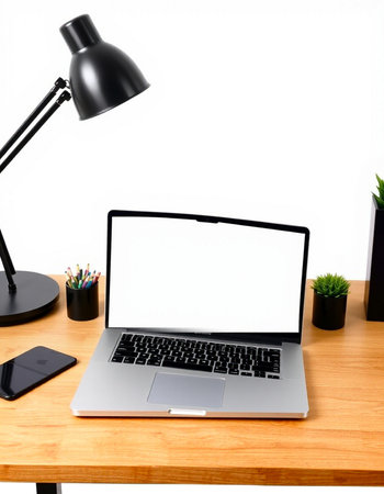 Modern workspace with blank screen laptop, smartphone, stationery and coffee cup on wooden table
