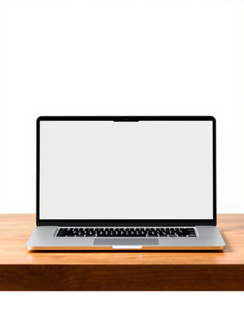 Laptop with blank screen on wooden table isolated on white background.