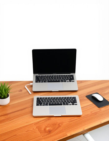 Laptop and mouse on wooden desk with white background. Workplaceの写真素材
