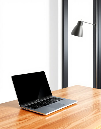 Laptop on a wooden table with a lamp in the corner of the room