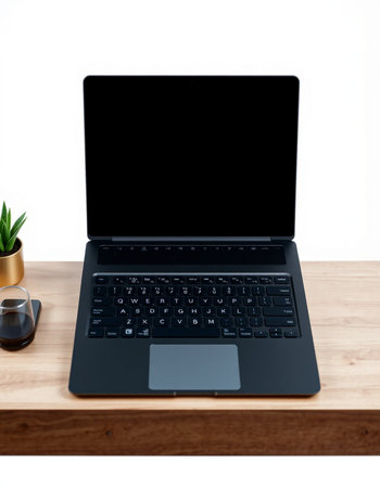 Laptop computer with blank screen on wooden table isolated on white background