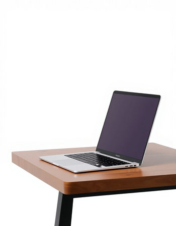 Laptop computer with blank screen on wooden table isolated on white background