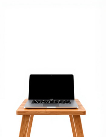 Laptop with blank screen on a wooden stool isolated on white background