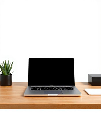 Laptop with blank screen on wooden table isolated on white background.