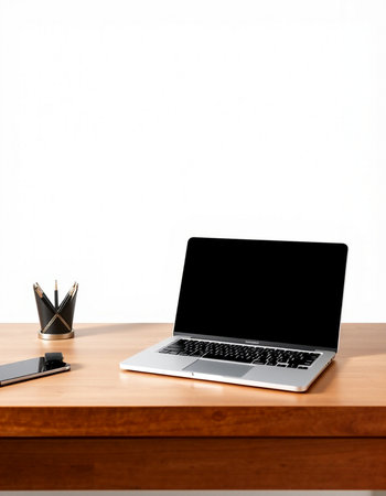Laptop with blank screen on wood table and white wall background.の写真素材