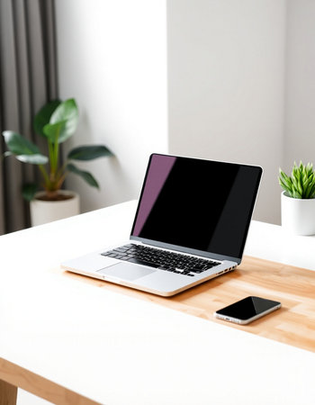 Laptop with blank screen on table in office. Mockup for design