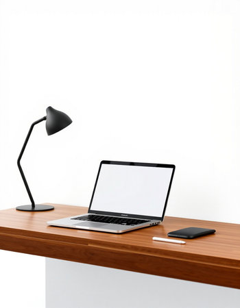 Laptop with blank screen on wood table and white wall background.