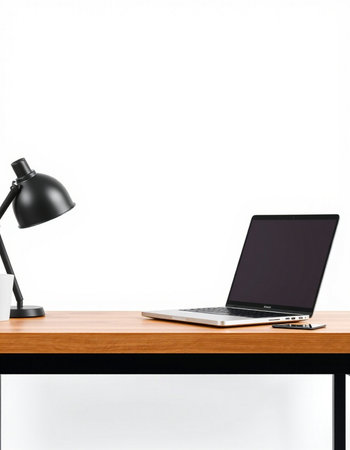 Laptop and lamp on wood table isolated on white background. Workplace concept