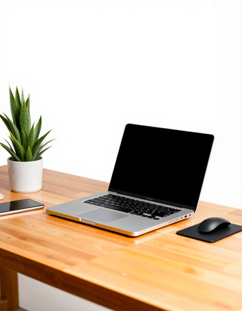 Laptop with blank screen on wooden desk and white wall background.