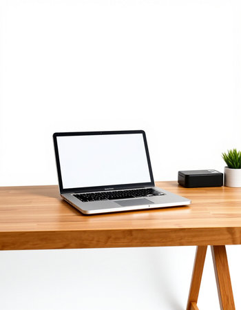 Laptop with blank screen on wooden desk isolated on white background.