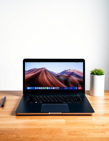 website on laptop in a creative room environment.