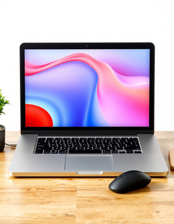 Laptop with colorful screen and mouse on wood desk isolated on white background