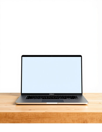 Laptop with blank screen on wooden table isolated on white background.の写真素材
