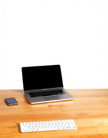 Laptop on a wooden desk with keyboard and mouse isolated on white background