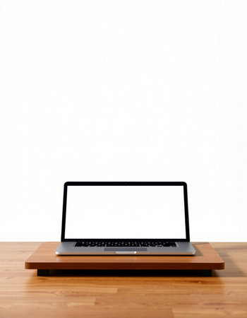 Laptop with blank screen on wood table and white wall background.の写真素材