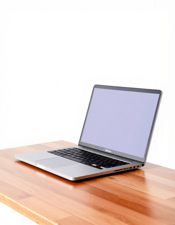 Laptop with blank screen on wooden desk isolated on white background.の写真素材