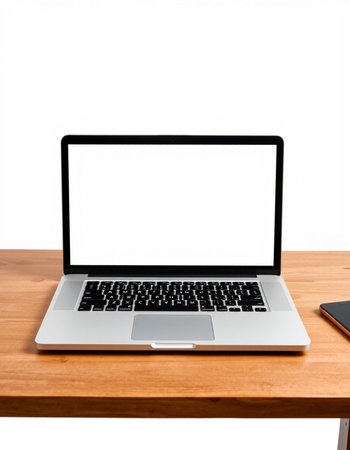 Laptop with blank screen on wooden table isolated on white background.