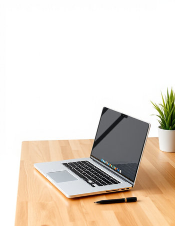 Laptop on wooden desk with white wall background, clipping path includedの写真素材