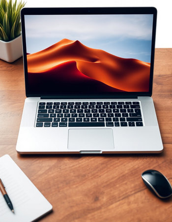 Digital composite of Laptop with red dune on screen over deskの写真素材