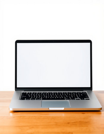 Laptop computer with blank screen on wooden table isolated on white background