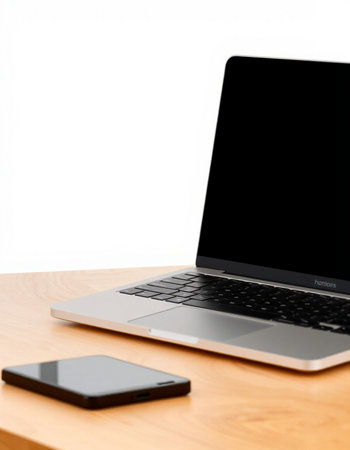 Laptop and smart phone on wooden table isolated on white background.