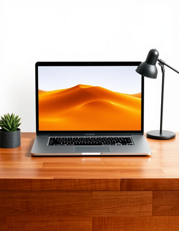 Laptop on a desk with a view of the sand dunes