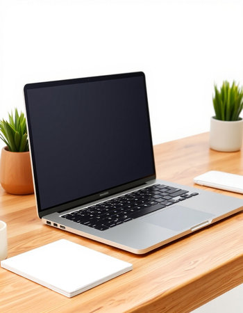 Laptop with blank screen on wooden desk. Workplace concept.