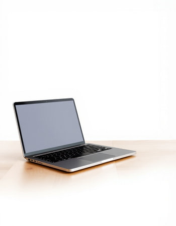 Laptop on wooden desk isolated on white background with clipping path.の写真素材
