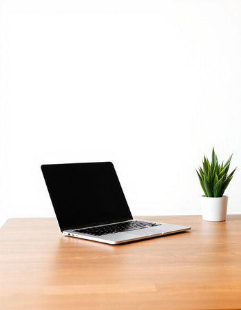 Laptop computer on wooden table and white wall background, stock photoの写真素材