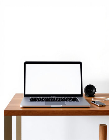Laptop computer with blank screen on wooden desk isolated on white background