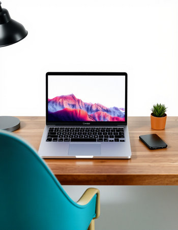 Laptop computer on a wooden table with a white wall background.