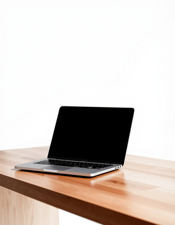 Laptop with blank screen on wood table isolated on white background.
