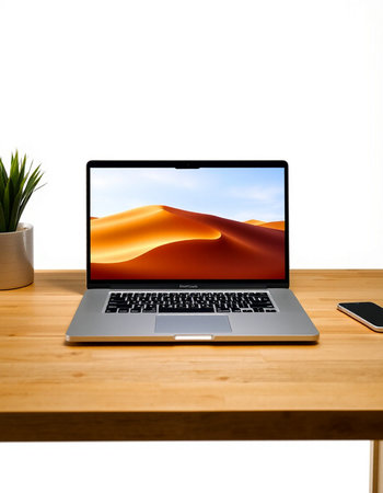 laptop on wood table with white background
