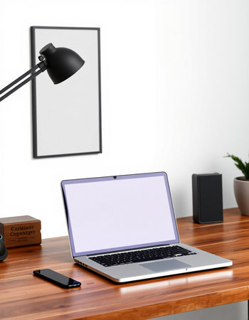 Modern workplace with blank screen laptop on wooden table.