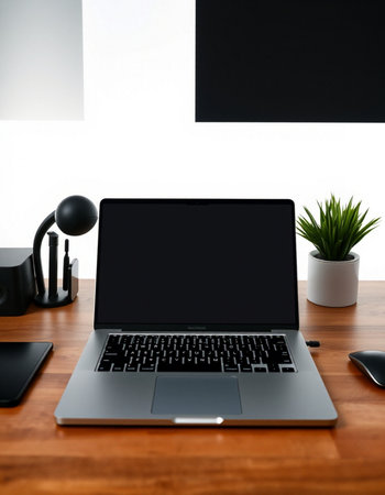 Laptop with blank screen on wood table in office room, stock photoの写真素材