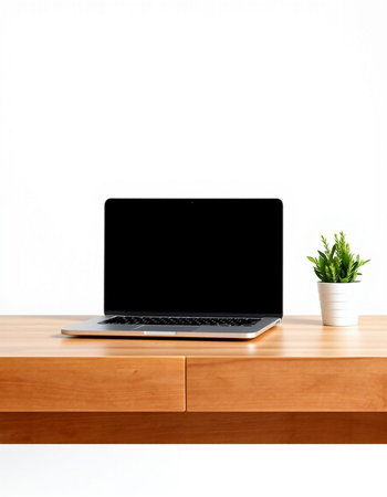 Laptop with blank screen on wooden table and white wall background.の写真素材