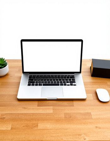Laptop computer with blank screen on wooden table and white wall background