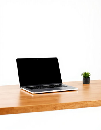 Laptop with blank screen on wooden table isolated on white background.の写真素材