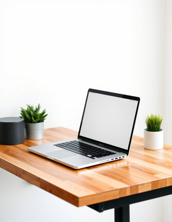 Laptop with blank screen on wooden table in modern living room.の写真素材