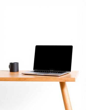 Laptop and coffee cup on wooden desk isolated on white background.の写真素材