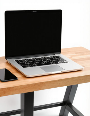 Laptop with blank screen on wooden table, isolated on white background