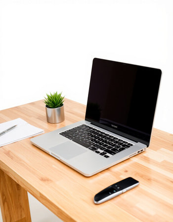 Laptop computer with blank screen on wooden desk isolated on white background