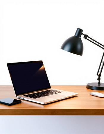 Laptop with blank screen on wooden table and lamp on white wall background