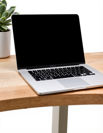 Laptop with blank screen on wooden table. Workplace concept.