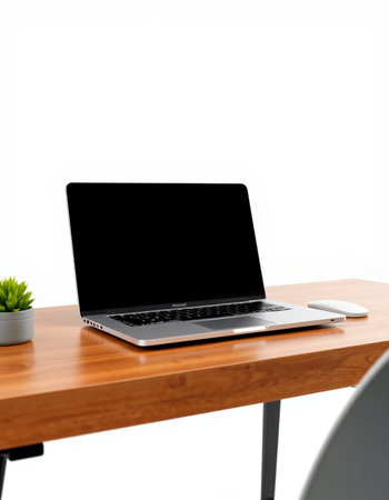 Laptop computer with blank screen on wooden desk isolated on white background