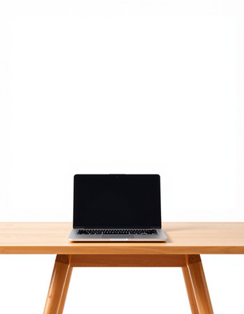 Laptop with blank screen on a wooden table isolated on white backgroundの写真素材