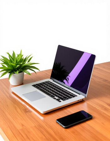 Laptop and smart phone on wooden desk with white wall background.