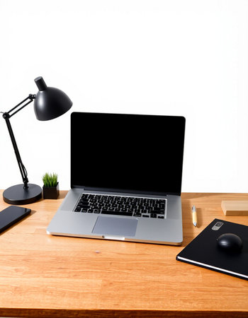 Laptop on wooden desk with lamp, mouse, keyboard and other objects