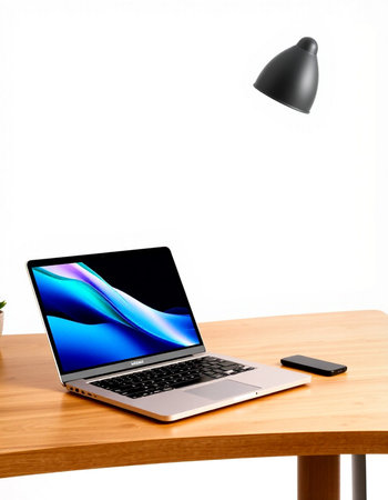 Laptop on a wooden desk with a black lamp in the background