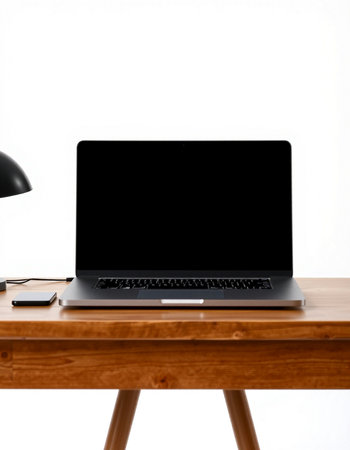 Laptop with blank screen on a wooden table against a white wallの写真素材